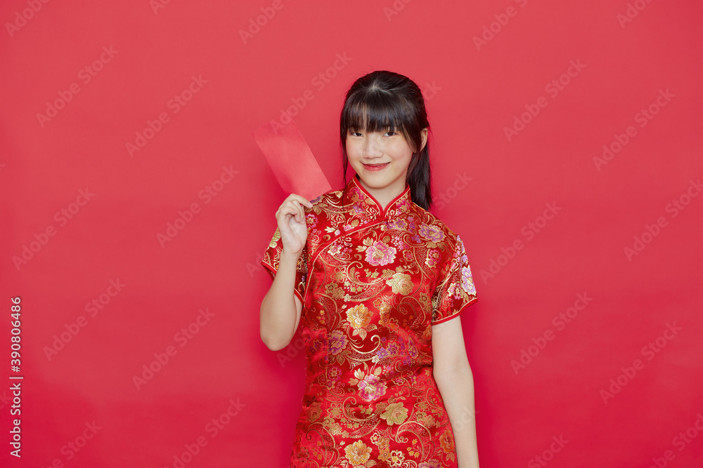 Young Asian woman wear a Chinese dress with a red envelope Young Asian woman wear a Chinese dress with a red envelope