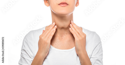 Woman palpation her neck, examine thyroid gland. Enlarged butterfly-shaped thyroid gland, isolated on white background