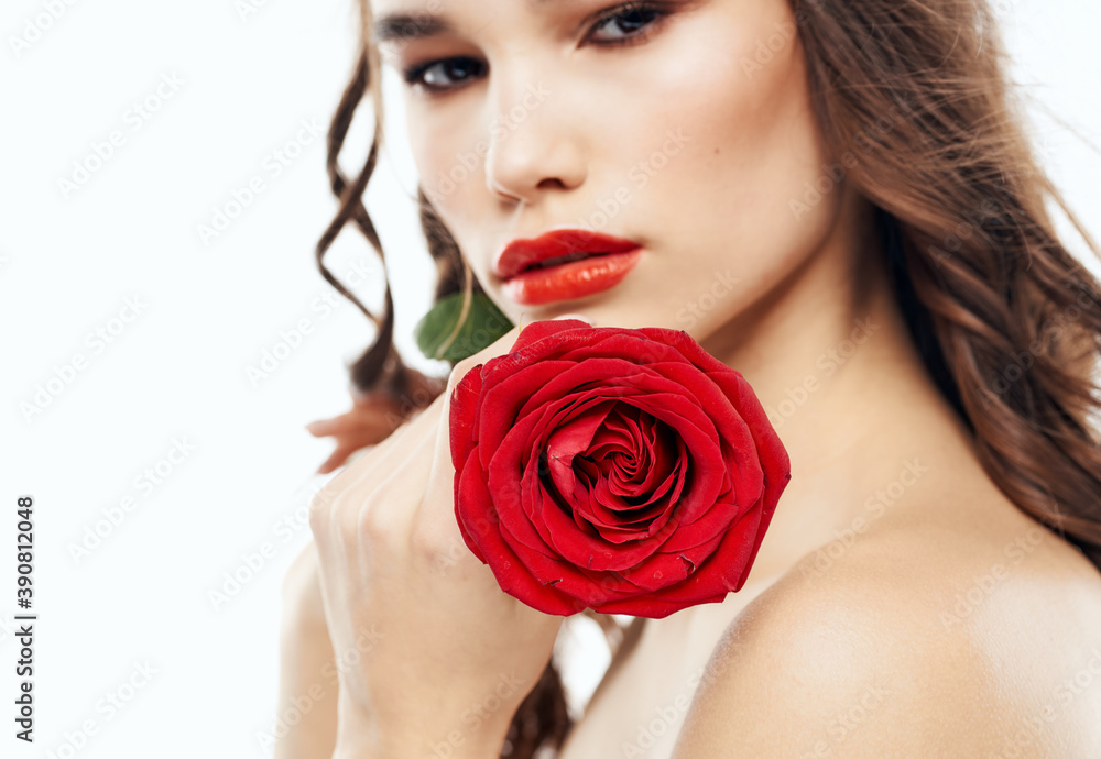 Romantic woman with red blossoming flowers near face cropped view of brunette makeup