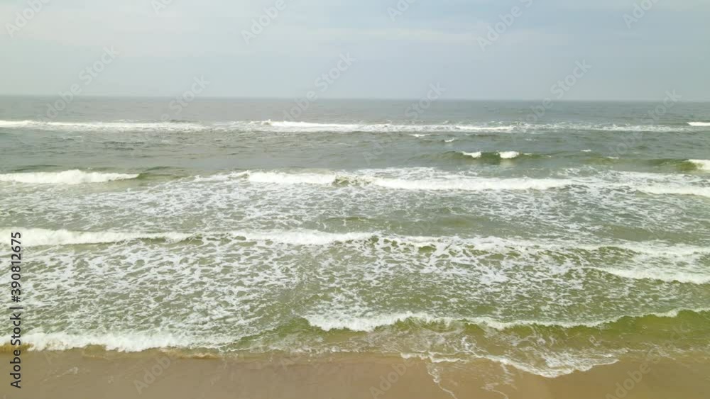 Aerial wide shot of stormy baltic sea with waves during cloudy day.Backwards flight Aerial wide shot of stormy baltic sea with waves during cloudy day.Backwards flight