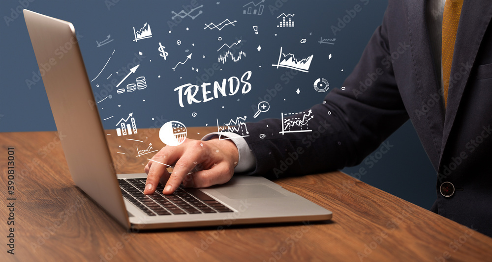 Businessman working on laptop with TRENDS inscription, modern business concept Businessman working on laptop with TRENDS inscription, modern business concept