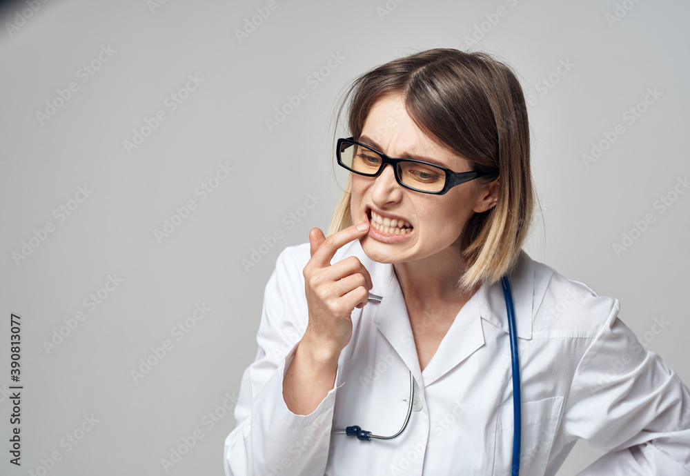 doctor in a medical gown with a stethoscope around his neck puzzled look gray background doctor in a medical gown with a stethoscope around his neck puzzled look gray background