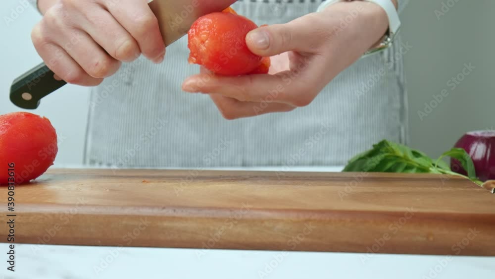 Close-up of peeling from skin tomatoes with a knife on a cutting board in 4K. Close-up of peeling from skin tomatoes with a knife on a cutting board in 4K.