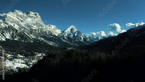 Aerial 4K Drone View of Cortina d'Ampezzo in the Dolomites, including Monte Antelao, Monte Cristallo, and Three Peaks Nature Park (Parco naturale Tre Cime) on a bright sunny spring day photo