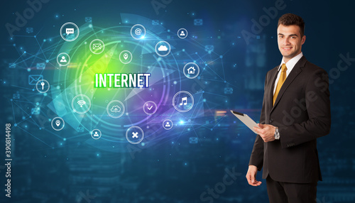 Businessman thinking in front of technology related icons and INTERNET inscription, modern technology concept