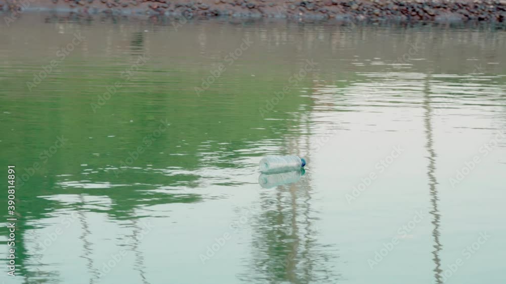 Water contaminated by careless people throwing plastic bottles and other toxic waste into ocean bringing harm to marine life and causing water pollution Water contaminated by careless people throwing plastic bottles and other toxic waste into ocean bringing harm to marine life and causing water pollution