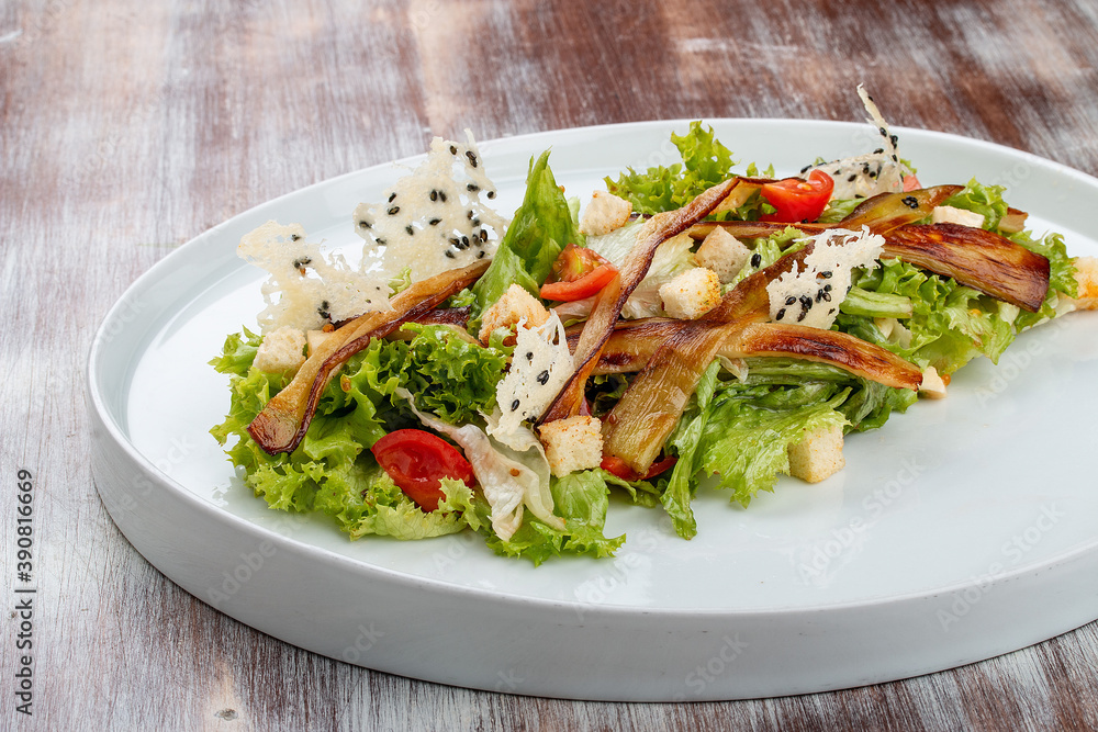 Salad with baked eggplant, mozzarella and romaine lettuce Salad with baked eggplant, mozzarella and romaine lettuce