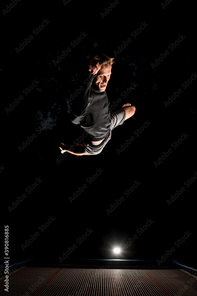 Man having fun and jump high on trampoline