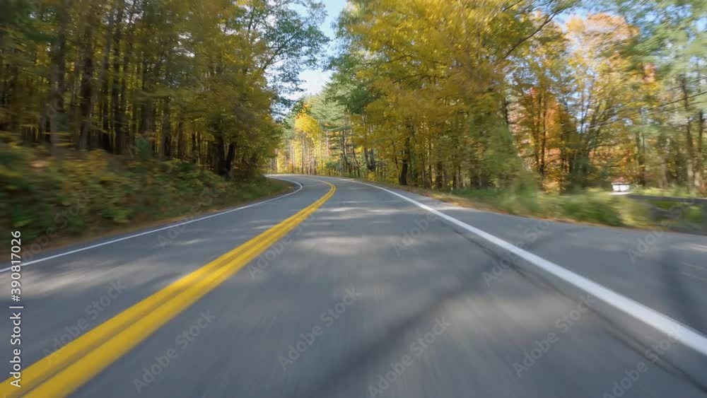 POV Driving a car on rural asphalt curvy road with colorful trees in autumn POV Driving a car on rural asphalt curvy road with colorful trees in autumn