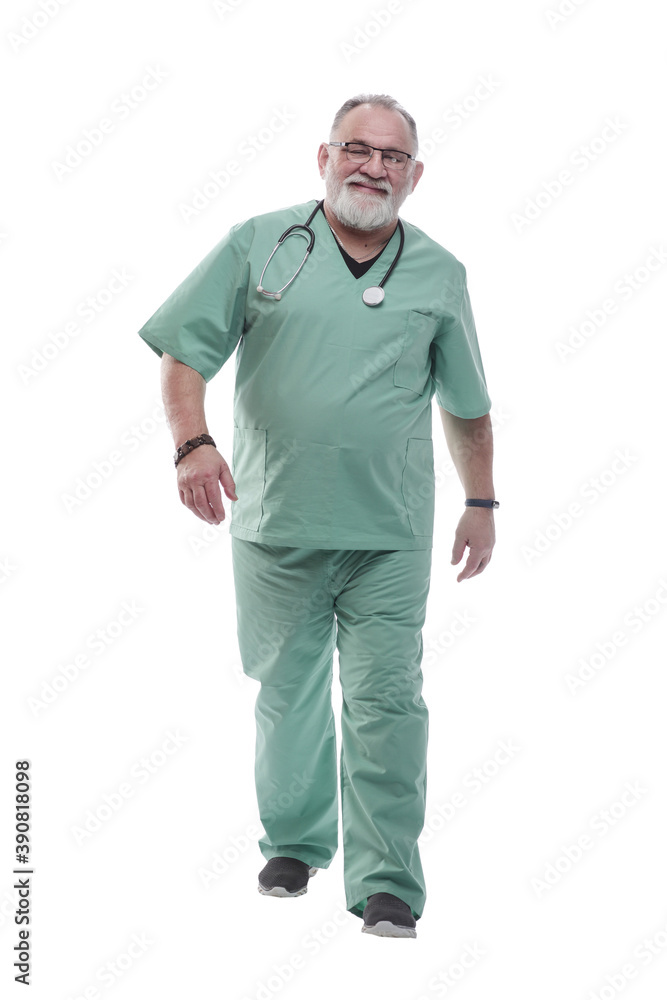in full growth. Mature doctor with a stethoscope confidently stepping forward in full growth. Mature doctor with a stethoscope confidently stepping forward