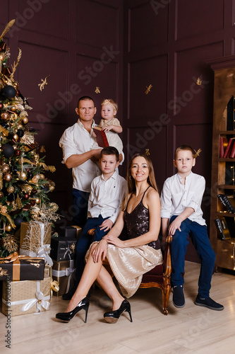 stylish beautiful family in smart clothes at the New Year photo shoot. dark studio design.
