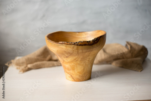 Wooden plate on a white table. National dishes. Crockery made from natural materials. Wood texture