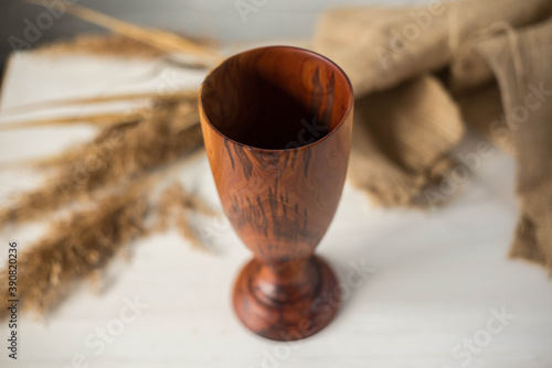 Glass made of wood. Craft wooden glass. Handmade wooden tableware.