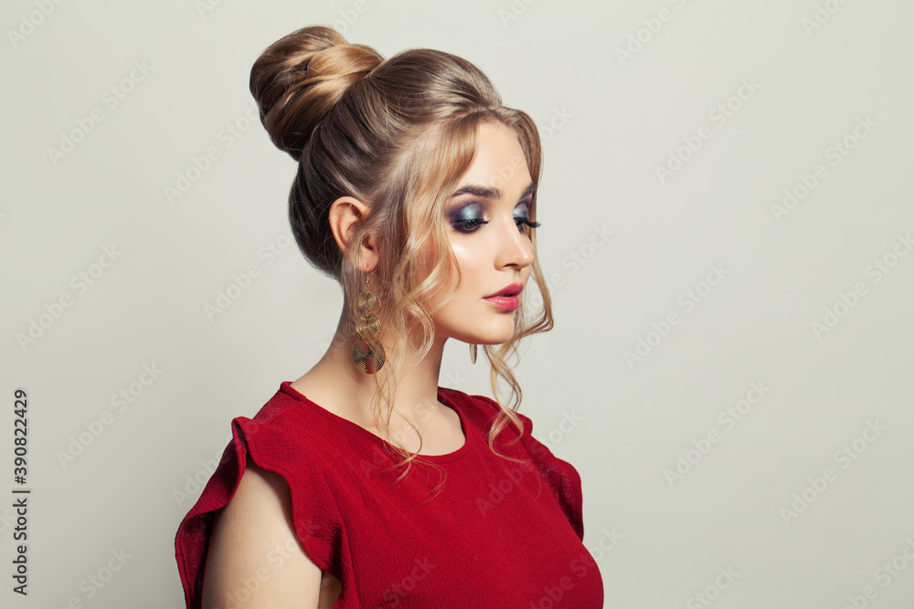 Beautiful model woman with trendy fashionable makeup wearing red dress