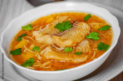 Fish soup with potato and noodles in bowl