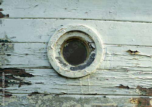 Small porthole in an old boat