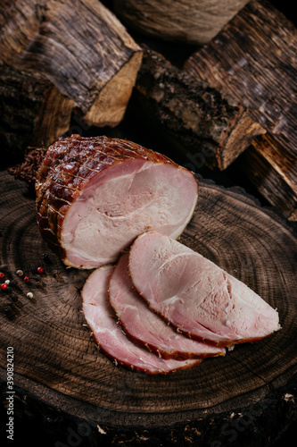 Smoked pork bacon half a piece on a wooden board, sliced ​​pork. Top view. Close up.