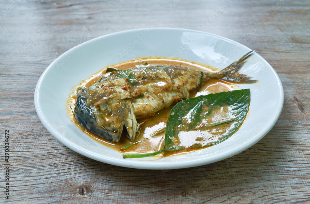 spicy boiled mackerel in red curry sauce on dish