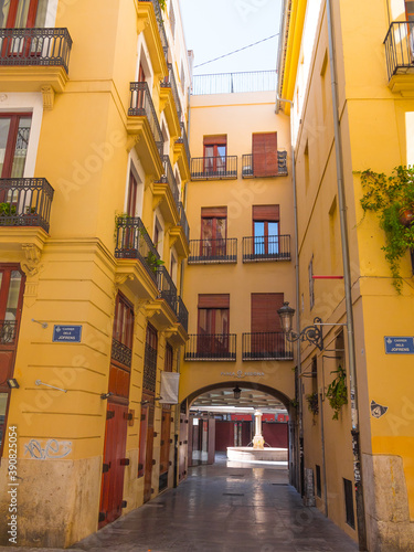 Beautiful typical spanish yellow street in Valencia, Spain. Colorful and historic architecture.