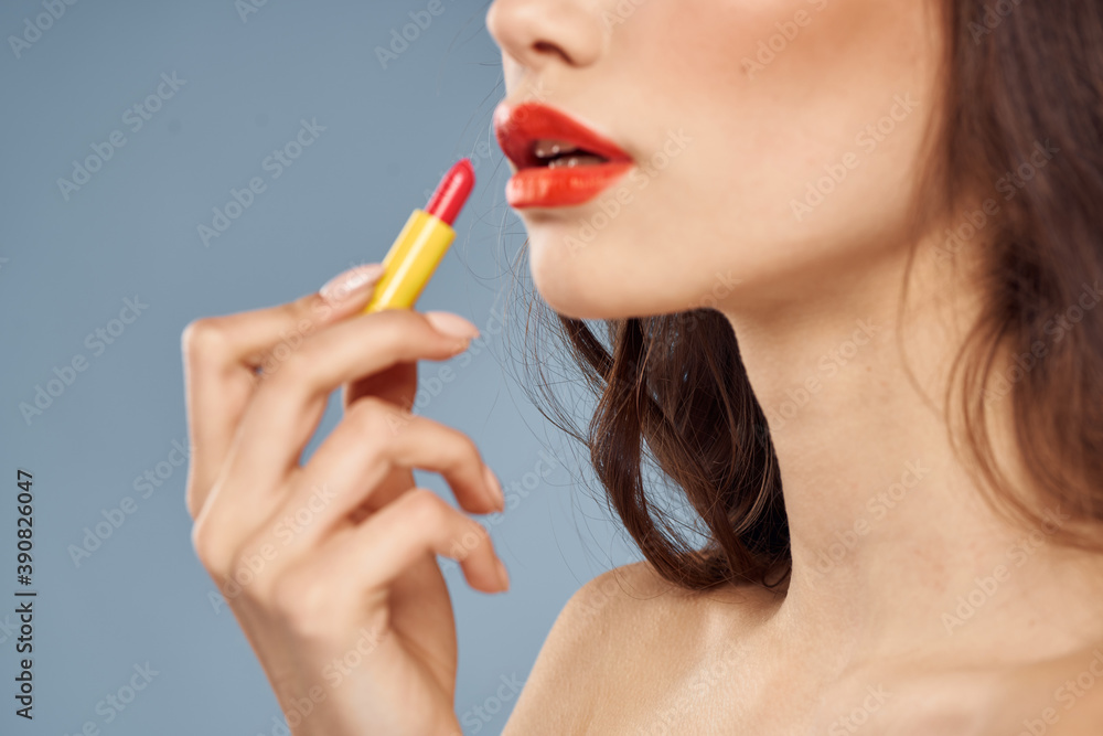 Woman with lipstick on a gray background brunette makeup with eye shadow on the eyelids Woman with lipstick on a gray background brunette makeup with eye shadow on the eyelids