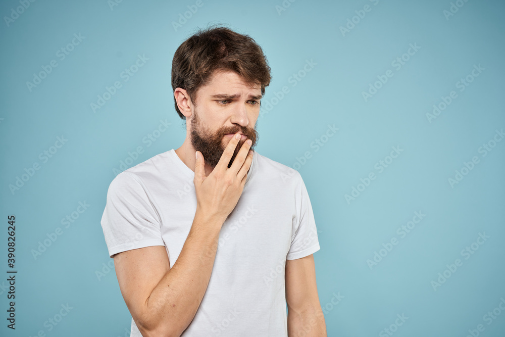 Bearded man emotions white t-shirt lifestyle gestures with hands blue backgrounds Bearded man emotions white t-shirt lifestyle gestures with hands blue backgrounds