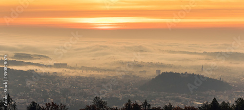 Panorama of Graz city covered if fog on autumn morning during sunraise. photo