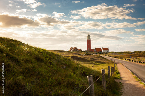 Iconic lighthouse surrounded by houses during sunset at the island of Texel, The Netherlands photo