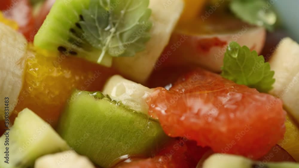 Close-up of a bowl of fruit salad with honey poured on it Close-up of a bowl of fruit salad with honey poured on it