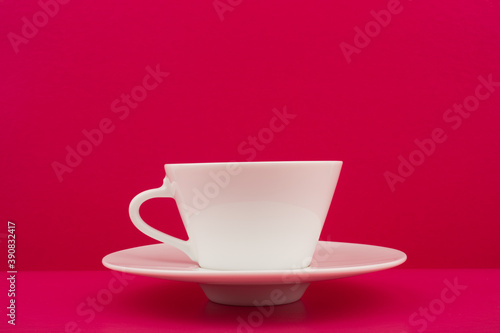 White coffee cup on a bright pink background
