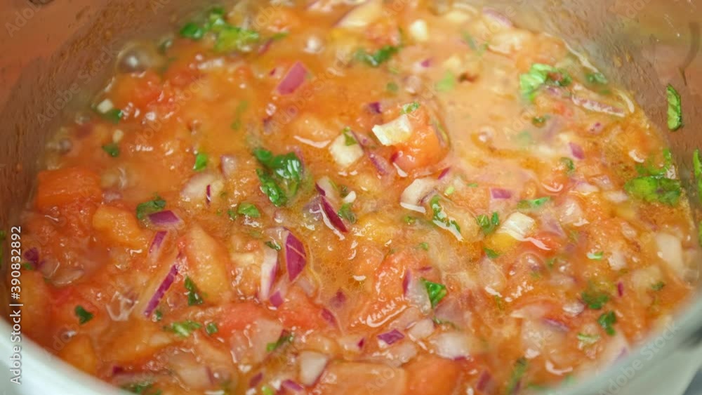 Close-up Frying in a saucepan ingredients sauce for Scallops on a gas stove. Concept of preparing a vegetable sauce from palm tomatoes, basil, onion, salt, and pepper, olive oil. Close-up Frying in a saucepan ingredients sauce for Scallops on a gas stove. Concept of preparing a vegetable sauce from palm tomatoes, basil, onion, salt, and pepper, olive oil.