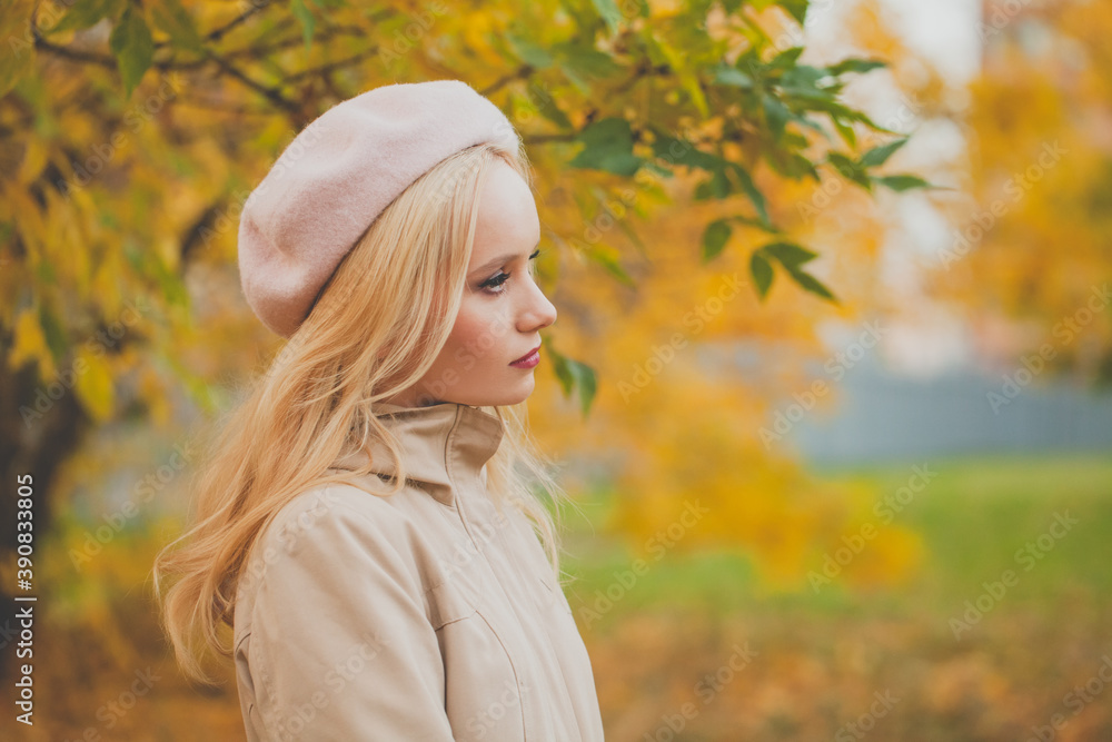 Beautiful woman on yellow autumn leaves background