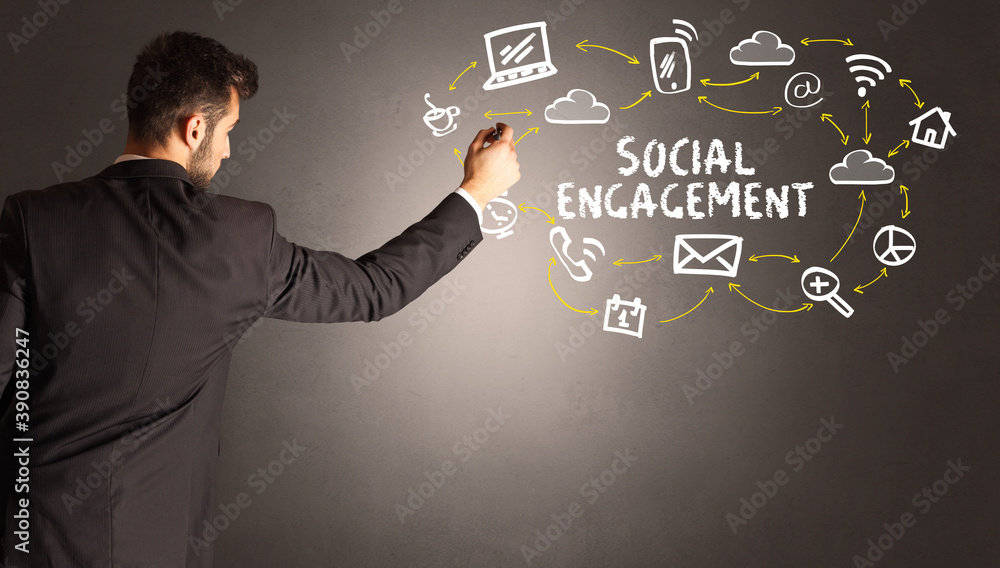 businessman drawing social media icons with SOCIAL ENGAGEMENT inscription, new media concept businessman drawing social media icons with SOCIAL ENGAGEMENT inscription, new media concept