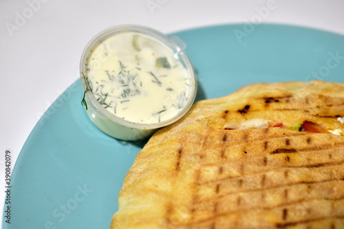 Burritos dener or Shawarma with sauce on a white plate photo