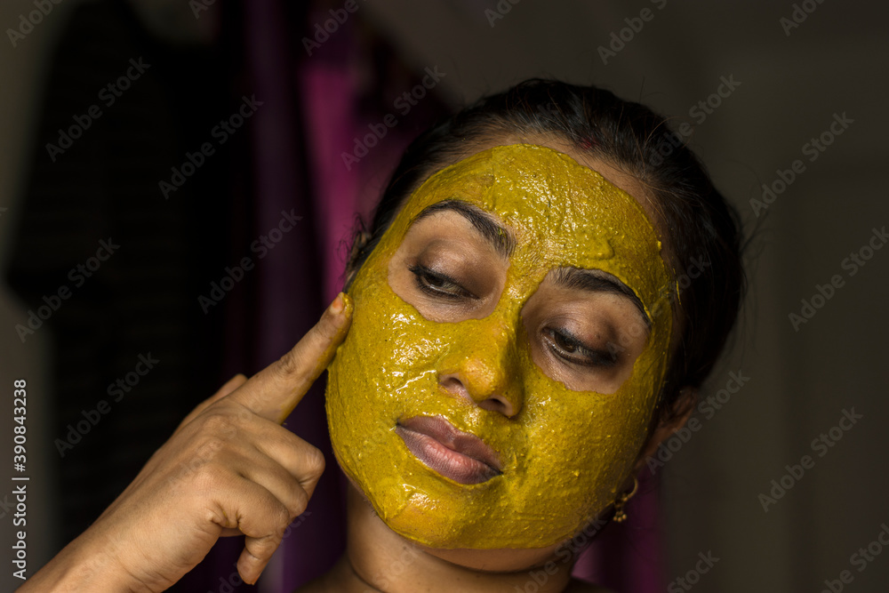 Close up of a woman with cosmetic facial mask all over her face. Close up of a woman with cosmetic facial mask all over her face.