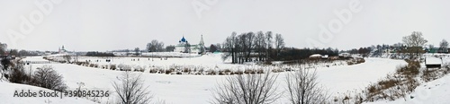 The panoramic view of Suzdal in winter on the Kamenka river, Cathedral of the Nativity of the Theotokos and the Kremlin in Russia.