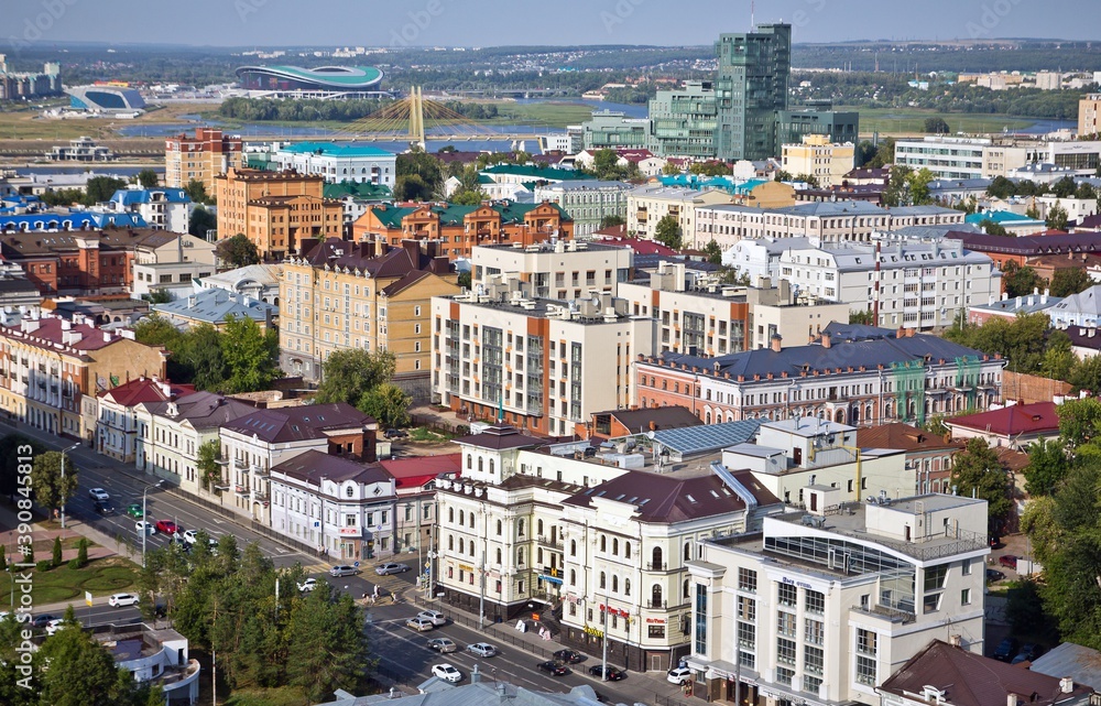 Obraz premium RUSSIA, KAZAN - AUGUST 15, 2014. Cityscape of Kazan in Russia: block full of houses and a road with cars, the bridge Millennium and Kazan Arena.