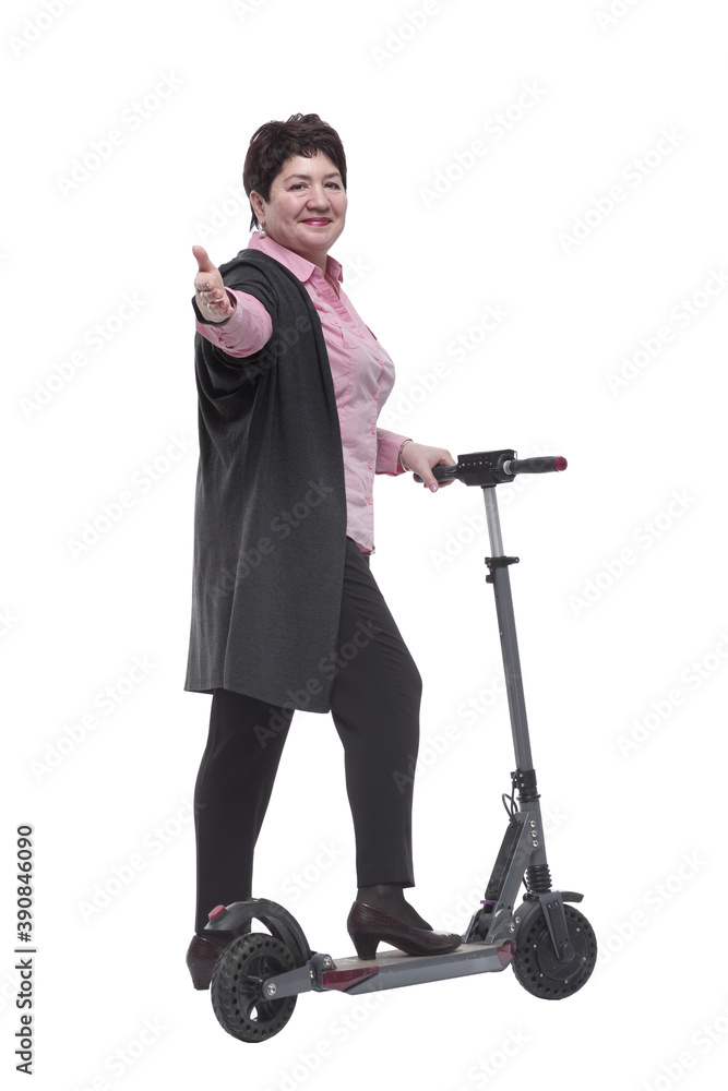 rear view. mature woman leaving on an electric scooter rear view. mature woman leaving on an electric scooter