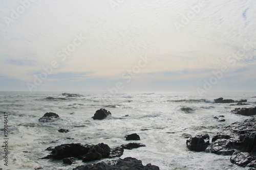 On the shore of the wild atlantic ocean in Yzerfontein, South Africa. Rocks and waves.