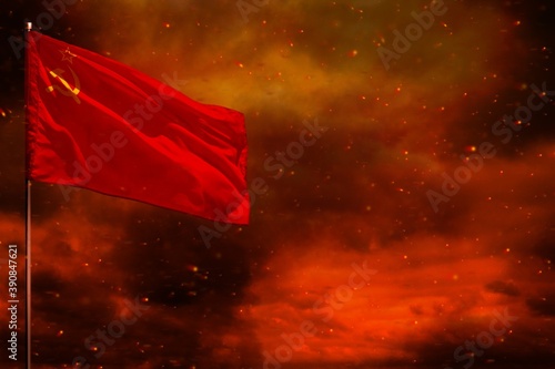 Billede på lærred Fluttering Soviet Union (SSSR, USSR) flag mockup with blank space for your text on crimson red sky with smoke pillars background