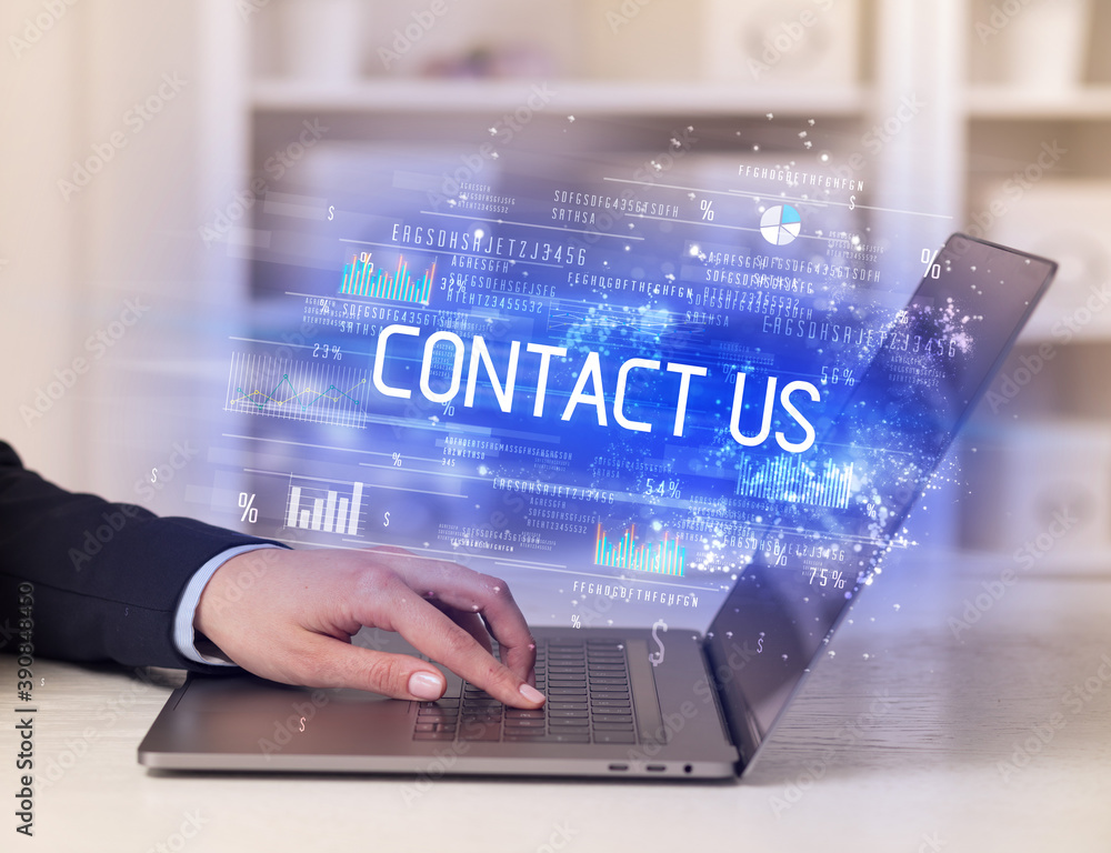 Closeup of businessman hands working on laptop with CONTACT US inscription, succesfull business concept Closeup of businessman hands working on laptop with CONTACT US inscription, succesfull business concept