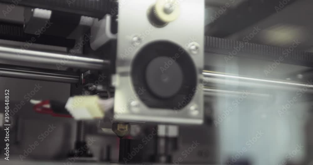 Modern additive technology concept. Working 3d printer is printing black plastic object or detail automatic, closeup. An automatic three-dimensional 3d printer making abstract plastic cube shape. Modern additive technology concept. Working 3d printer is printing black plastic object or detail automatic, closeup. An automatic three-dimensional 3d printer making abstract plastic cube shape.