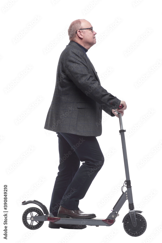 side view . Mature man with electric scooter looking forward side view . Mature man with electric scooter looking forward