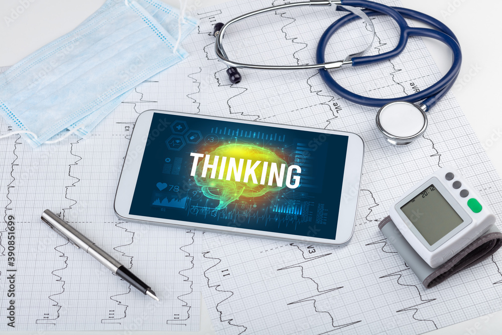 Tablet pc and medical tools with THINKING inscription, social distancing concept