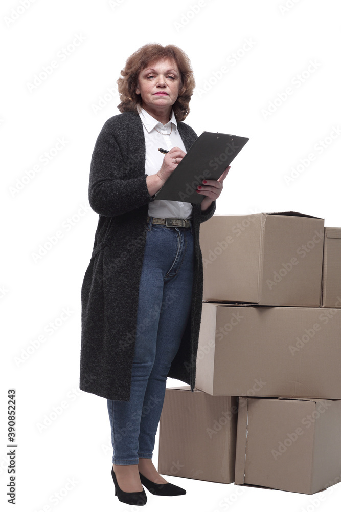 in full growth. serious woman signs documents after delivery. in full growth. serious woman signs documents after delivery.