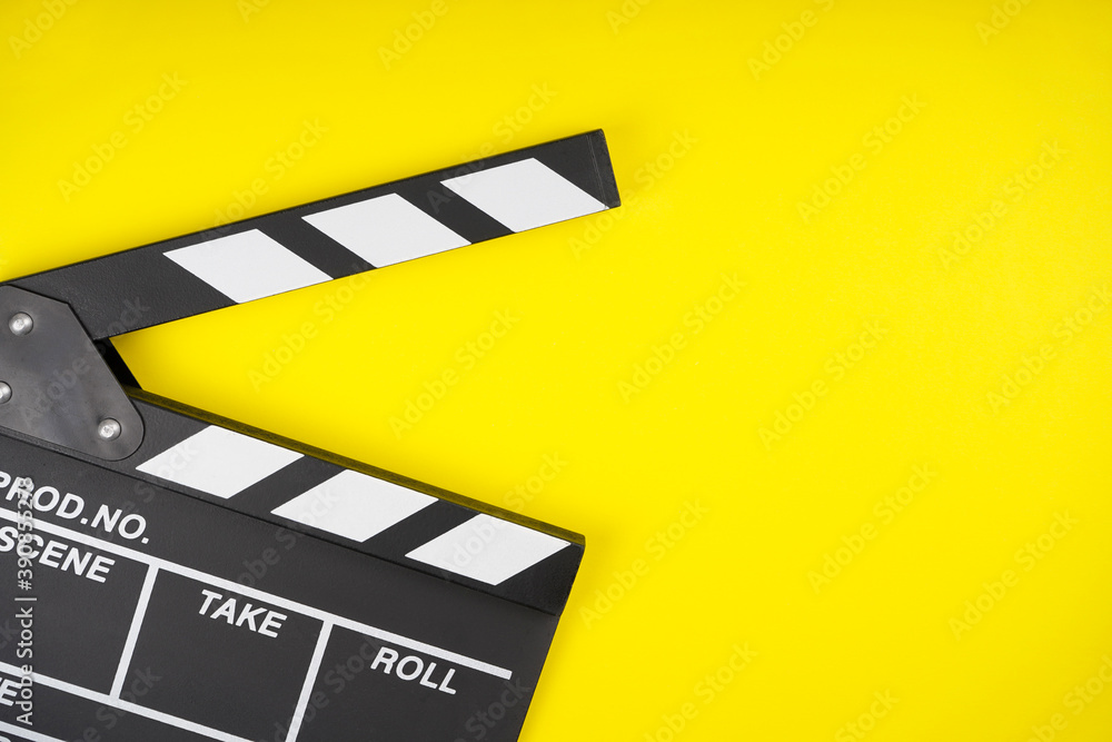 Clapperboard on yellow background. Movie, filmmaking, cinema concept. Top view, flat lay, copy space