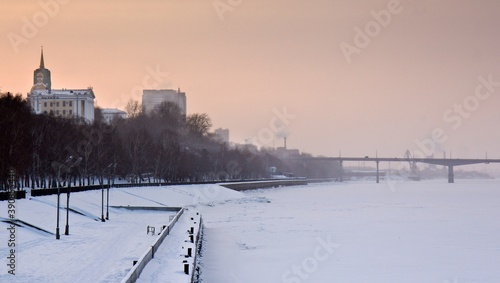 The embankment of the Kama river and the bridge over it in snowy winter in Perm, Russia.