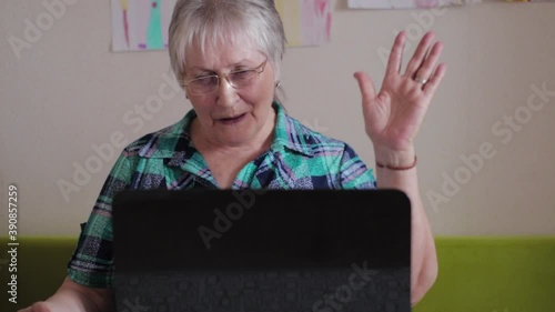 Older woman at a laptop. Woman talking on the Internet during quarantine, video