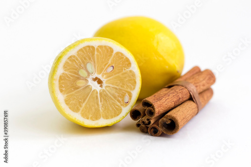 Lemon and cinnamon sticks on a white background.