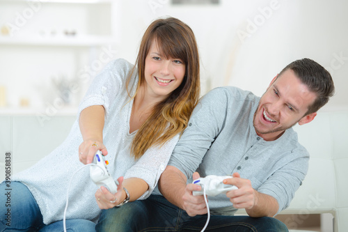 happy couple playing video game photo