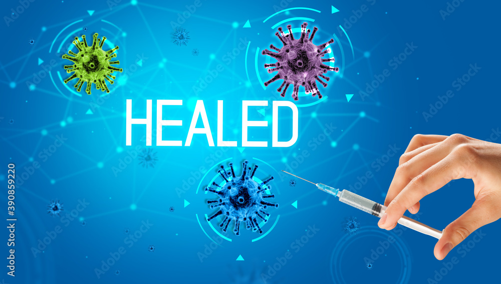 Syringe, medical injection in hand with HEALED inscription, coronavirus vaccine concept Syringe, medical injection in hand with HEALED inscription, coronavirus vaccine concept